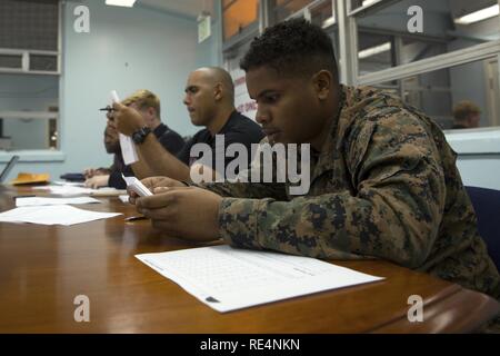 Students study Japanese characters during a Survival Japanese Language Class Nov. 29, 2016 on Marine Corps Air Station Futenma, Okinawa, Japan. The class provided students with the opportunity to learn to speak, read and write basic Japanese words, phrases and characters. The lesson covered the three basic Japanese forms of writing called hiragana, katakana and kanji. Stock Photo