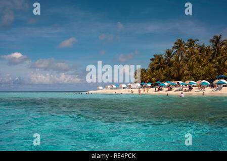 Tropical travel destination with tourists enjoying the turquoise water and white sand. Johnny Cay, San Andrés island, Colombia. Oct 2018 Stock Photo