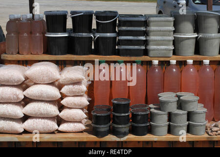 Bags of salt, jars of curative mud, bottles of curative salt solution standing on the counter on the bank of Sivash Lake Stock Photo