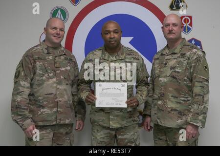 Sgt. 1st Class Essie L. Graves, 184th Sustainment Command, stands with the Inspector General team of 184th Sustainment Command after being sworn as the newest IG at Camp Arifjan, Kuwait Jan 6, 2019. Stock Photo
