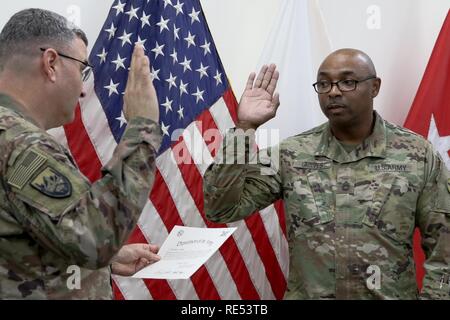 Sgt. 1st Class Essie L. Graves, 184th Sustainment Command, is sworn in as an Inspector General, by Brig. Gen. Clint E. Walker, at Camp Arifjan, Kuwait Jan 6, 2019. Stock Photo