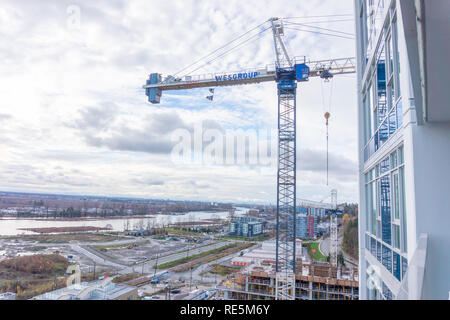Wesgroup branded construction crane lift, stationed at Vancouver's new River District while under development Stock Photo