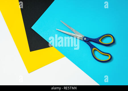 Abstract color paper and colorful papers background with scissors on top. Sheets of colored paper for drawing and school. White space for text with co Stock Photo
