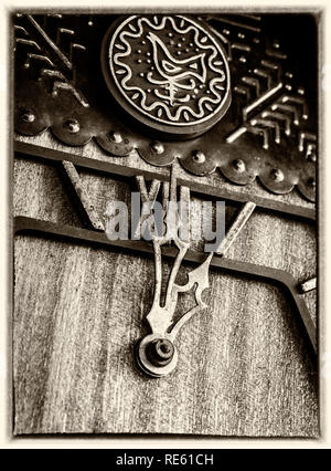 Old wooden cuckoo clock in old photo style closeup. Stock Photo