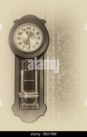 Wall pendulum clock with the fight in the old style. Stock Photo