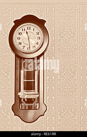 Wall pendulum clock with the fight in the old style. Stock Photo