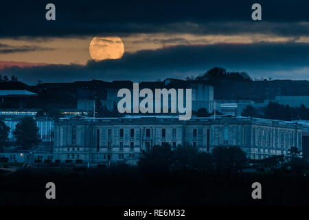 Aberystwyth, UK. 20 Jan 2019.   The first full moon  of 2019 is seen rising over the National Library of Wales in Aberystwyth Wales UK.  The January full moon is sometimes called a 'wolf moon', and is this time also a 'supermoon', being a little closer to the earth and appearing larger and brighter han normal full moons.  In a few hours this moon will be eclipsed by the earth and will appear to glow red in the early morning sky above the UK  photo credit  Keith Morris / Alamy Live News Stock Photo