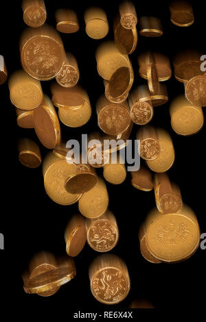 Gold chocolate coins falling with blur on a black background