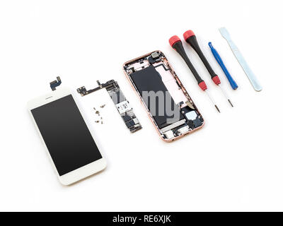 Disassembled broken smartphone preparing to repair or replace new part on white background Stock Photo