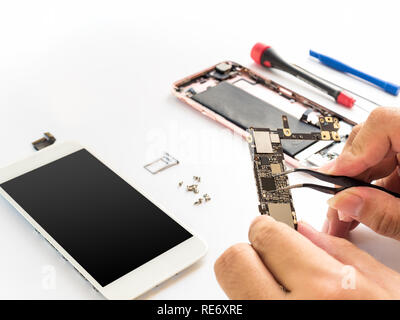 Close-up of technician hand clamping processor on smartphone logic board on smartphone component background with copy space Stock Photo