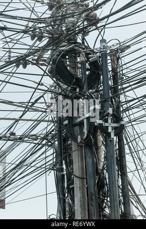 Abstract background surface of bunch of black wires connected on the pillars in Bali island, Indonesia Stock Photo