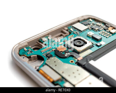 Close-up of inside broken smartphone disassembled preparing to repair on white background, Fucus on rear camera Stock Photo
