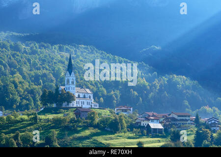 Dreznica Church of Sacred Heart and sun rays, near Kobarid, Primorska, Slovenia Stock Photo