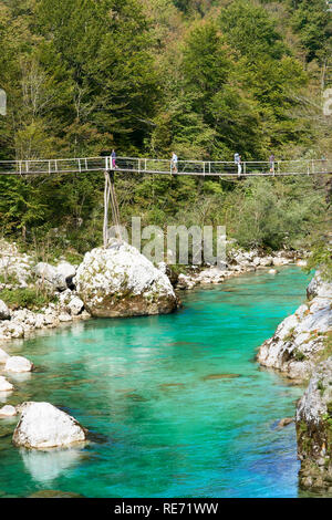 Tourist walking on suspension bridge across the River Soca, near Kobarid, Primorska, Slovenia Stock Photo