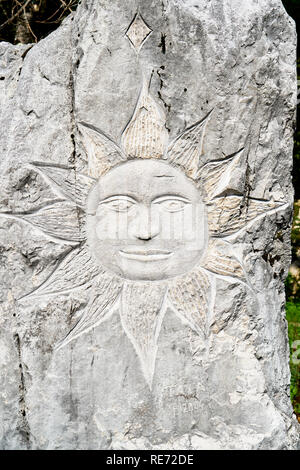 Stone carving of the sun, part of the 'Beauty in wood and stone', ' Lepota v lesu in kamnu', series of artworks between Dreznica and Kosec Stock Photo