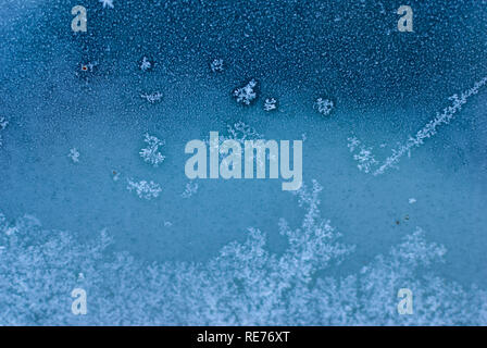 Blue ice flowers and crystals on the window Stock Photo