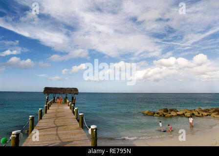 Wooden pier at Hotel Compass Point Resort at Love beach Nassau, Bahamas, Caribbean. Brightly Colored Cottages At Compass Point Beach Club. Stock Photo