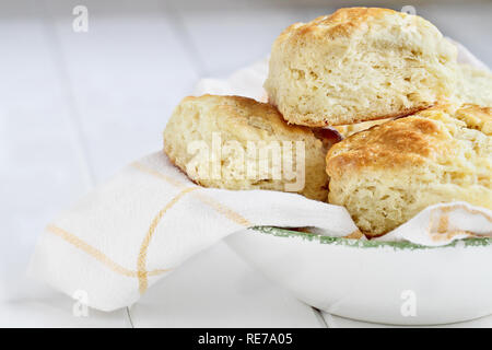 Fresh buttermilk southern biscuits or scones from scratch in a white bowl. Stock Photo