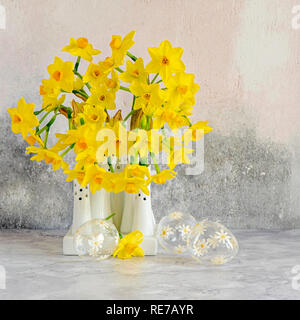 Beautiful spring, yellow Narcissus 'Tête-à-tête' - Daffodils arranged in white porcelain vases
