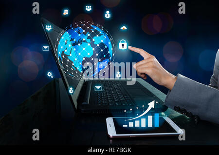 The phone has a Business graph icon. Press enter button on the computer. business logistics Communication network World map send message Connect world Stock Photo
