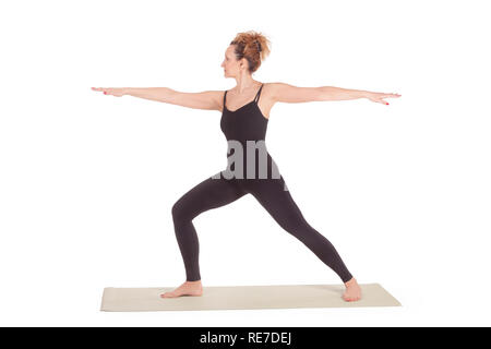 Beautiful Yoga: Warrior pose two - Real senior woman practitioner doing Virabhadrasana 2 exercise Stock Photo