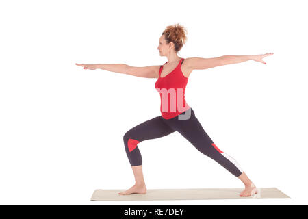 Beautiful Yoga: Warrior pose two - Real senior sporty woman practitioner doing Virabhadrasana 2 exercise Stock Photo
