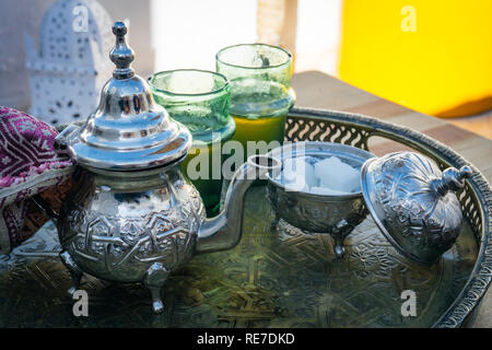 Arabian Mint Tea (Moroccan Mint Tea) The national hot drink in the Middle East and the Muslim world. Served in a special iron silver teapot with sugar Stock Photo