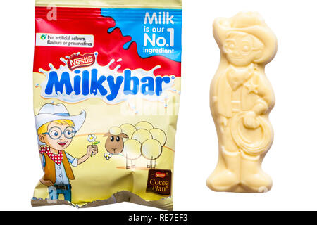 milkybar small bar unwrapped showing Milkybar Kid and bag of milky bar white chocolate buttons from Nestle Milkybar selection pack on white background Stock Photo