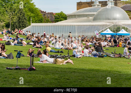 Glasgow, Scotland - May 19, 2018: View of a park in front of the botanic gardens in Glasgow, where people enjoy the late spring sunny day on May 19, 2 Stock Photo
