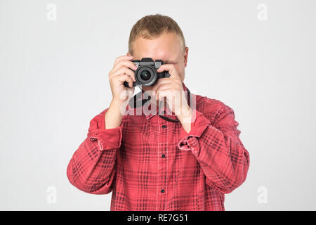 Handsome young man holding vintage old-fashioned film camera Stock Photo