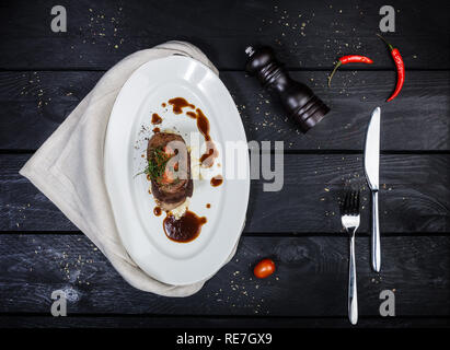 Beef tongue with celery root sauce and tomatoes. Stock Photo