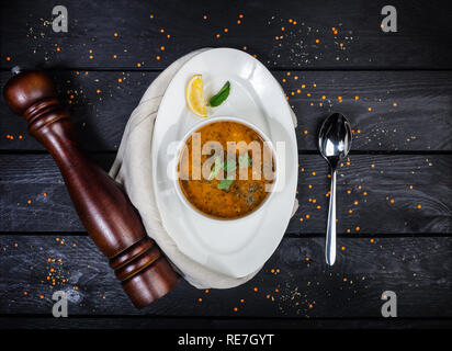 Red lentil soup served in white bowl Stock Photo