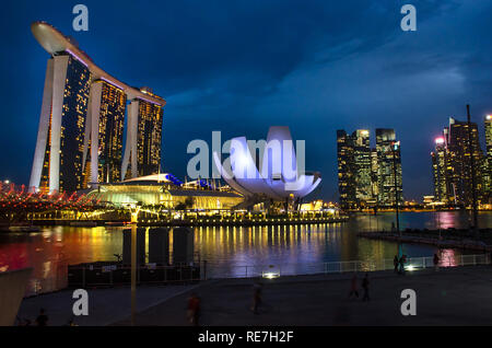 Singapore, Southeast Asia - December 14, 2018: Panoramic view under blue sky of The Helix Bridge, Marina Bay Sands Hotel and Art and Science museum. Stock Photo