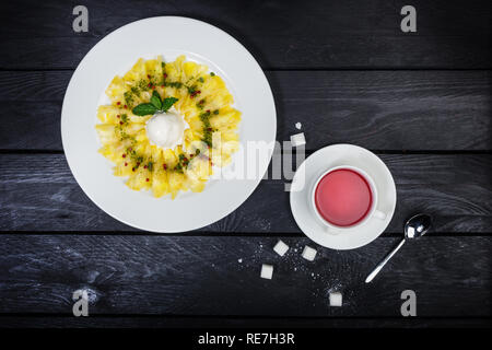 Carpaccio of pineapple with vanilla ice cream. Dessert. Stock Photo