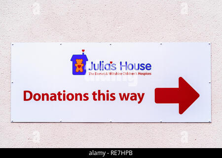 Julias house charity shop donations this way sign Stock Photo