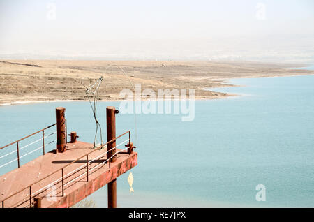 Jetty with fisherman sculpture at the Dead Sea (West Bank), hypersaline and lowest lake in the world, at -430m below sea level Stock Photo