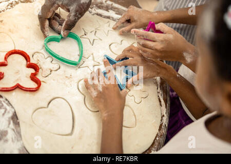 Top view of happy family forming cookies all together Stock Photo