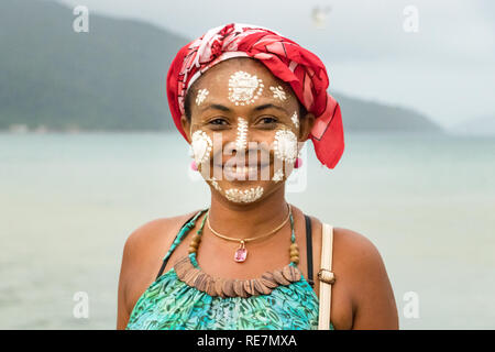Portrait of a Malagasy woman with her face painted, Vezo-Sakalava tradition, Nosy Be, Madagascar. Stock Photo