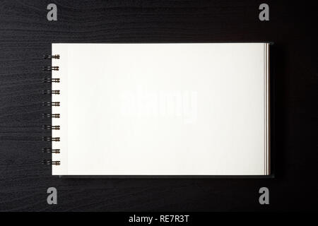 White empty notebook on black table, top view Stock Photo