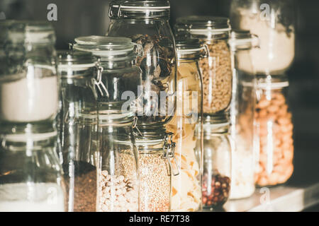Grains, cereals, nuts, dry fruit, pasta in glass jars Stock Photo