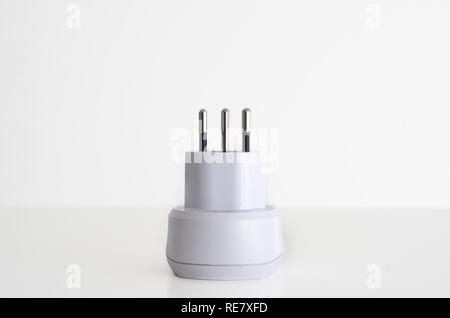 Power outlet adapter white with 3 pins swiss against white background Stock Photo
