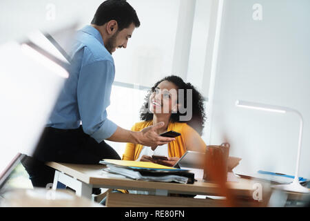 Business People Laughing In Office Watching Video Pictures On Smartphone Stock Photo