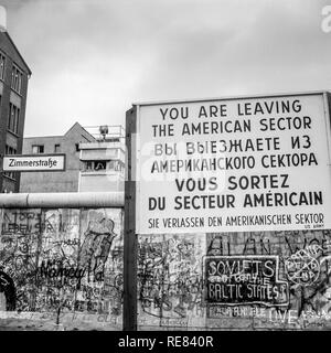 August 1986, leaving American sector warning sign, Berlin Wall graffitis, East Berlin watchtower, Zimmerstrasse street sign, West Berlin, Germany, Stock Photo