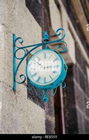 The vintage city clock in the street on a warm sunny day. Stock Photo