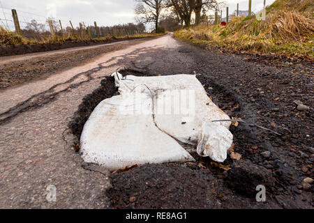 Pot Holes on single track road near Moniack, Inverness. Stock Photo