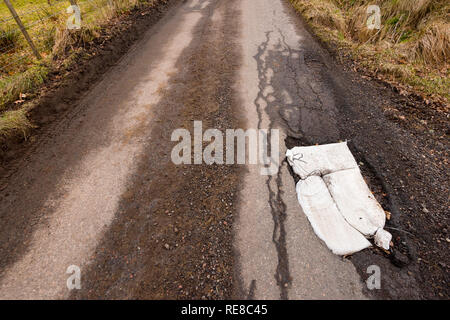 Pot Holes on single track road near Moniack, Inverness. Stock Photo