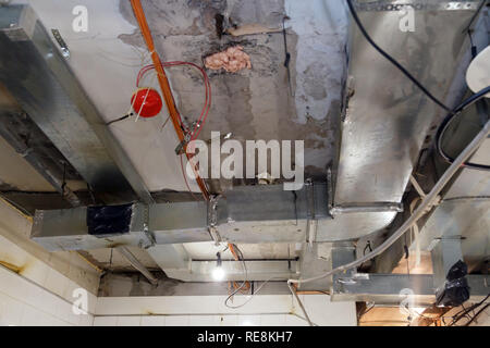 Installation and repair of frame, ventilation system, fire alarm, electric cable, lamp bulb before assembling stretch or suspended ceiling. Concept of Stock Photo