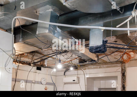 Installation and repair of frame, ventilation system, electric cable, lamp bulb before assembling stretch or suspended ceiling. Concept of reconstruct Stock Photo