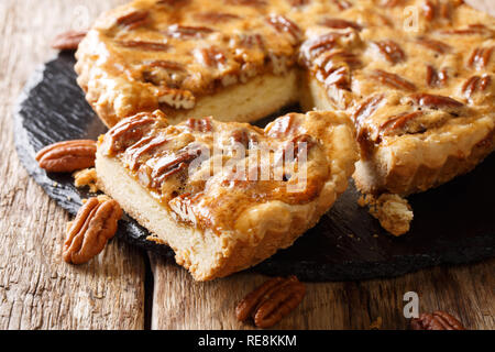 Traditional sliced American pecan pie close-up on the table. horizontal Stock Photo