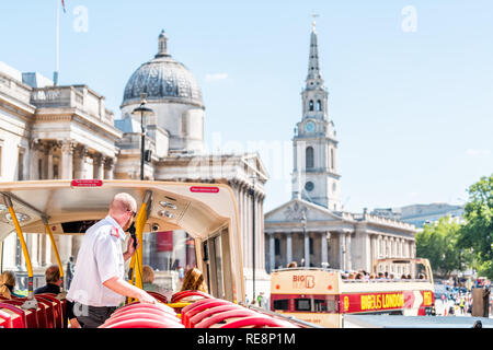 London, UK - June 22, 2018: Top of Big Bus double decker with guided tour guide and tourists sitting in seats with view of National Gallery buildings Stock Photo